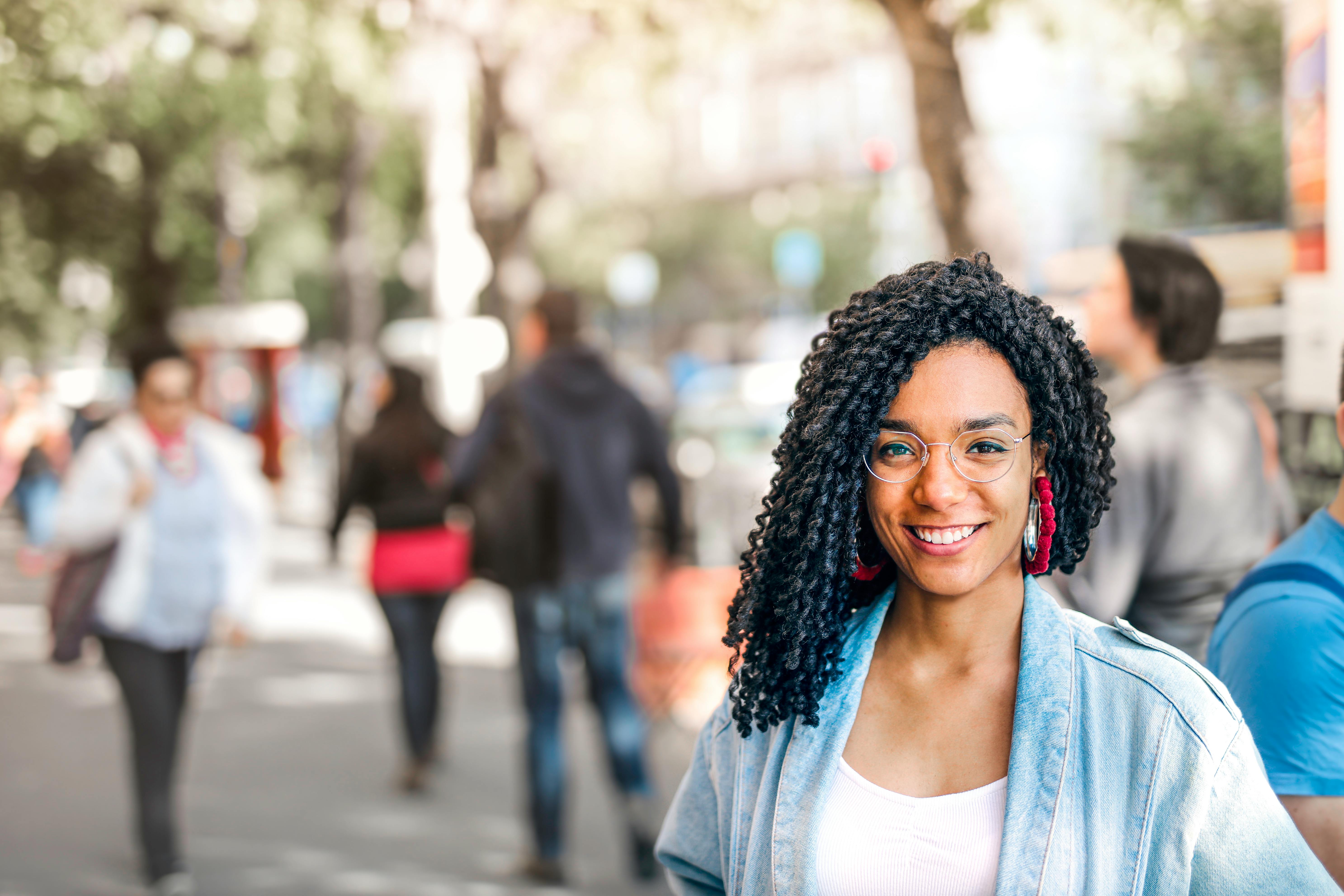 Woman smiling on a busy street